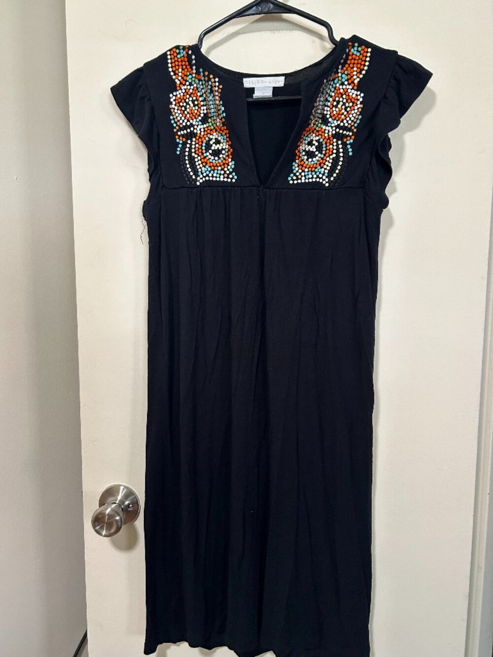 Design History -- black mini dress, ruffle sleeves, colorful design on chest